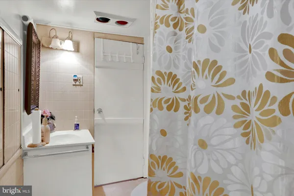 a bathroom with a sink vanity and a mirror
