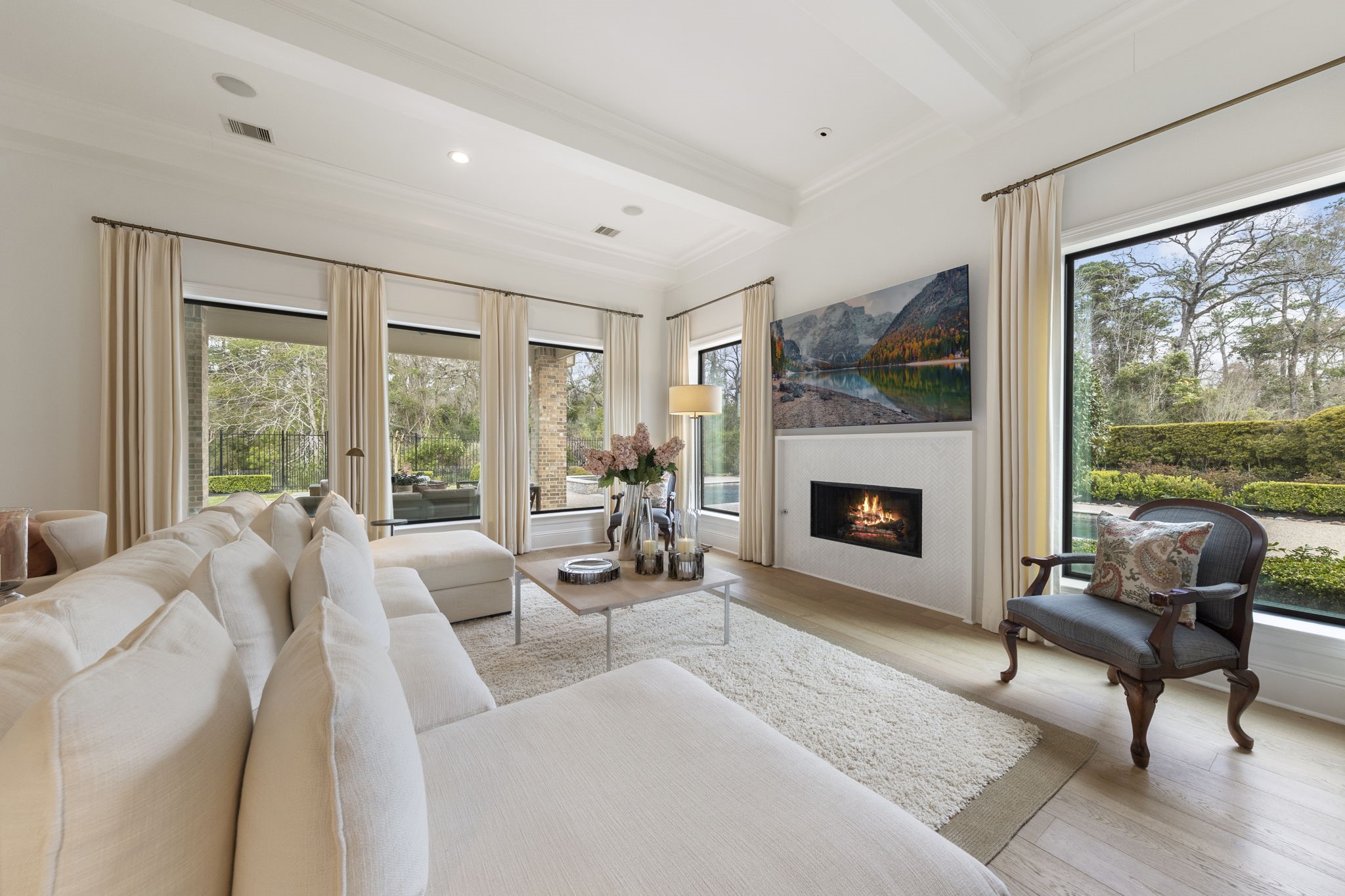70 Lake Reverie Place Tomball, TX 77375 - Photo 14 of 33 a living room with furniture a fireplace and a floor to ceiling window