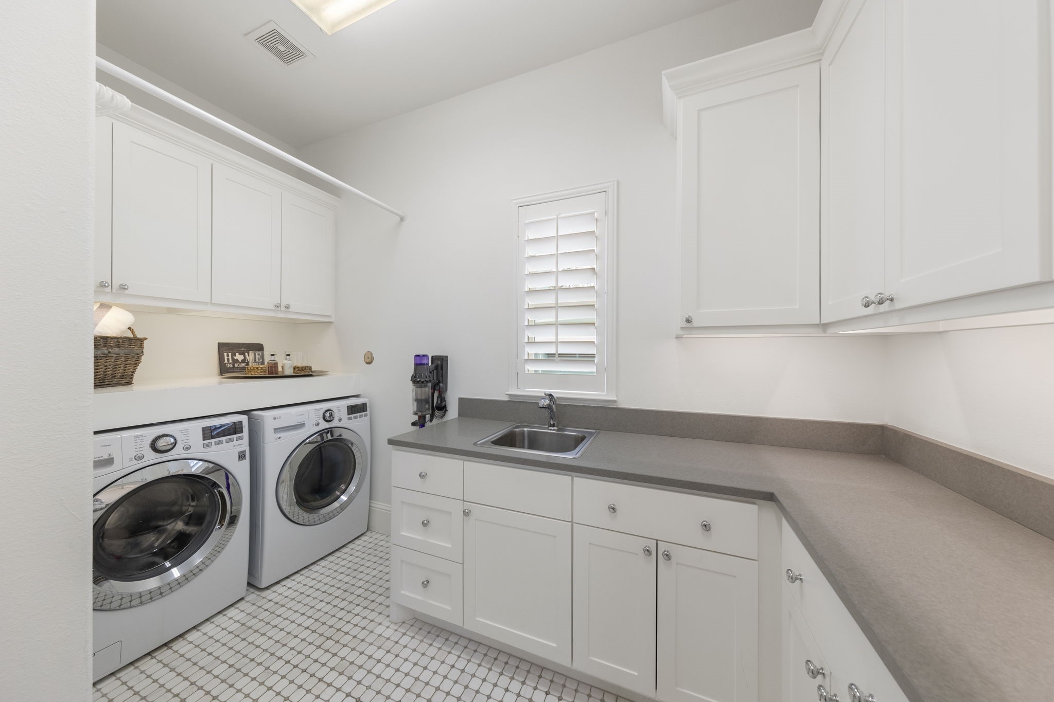 70 Lake Reverie Place Tomball, TX 77375 - Photo 23 of 33 a kitchen with white cabinets sink and washer dryer