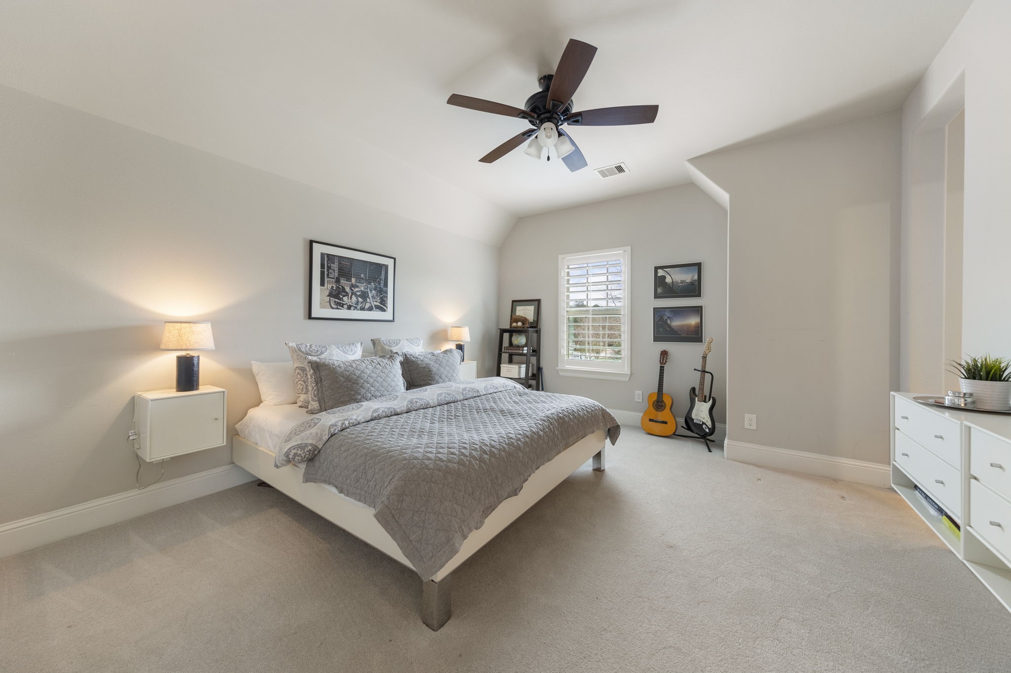 70 Lake Reverie Place Tomball, TX 77375 - Photo 27 of 33 a bedroom with a bed a couch and a ceiling fan