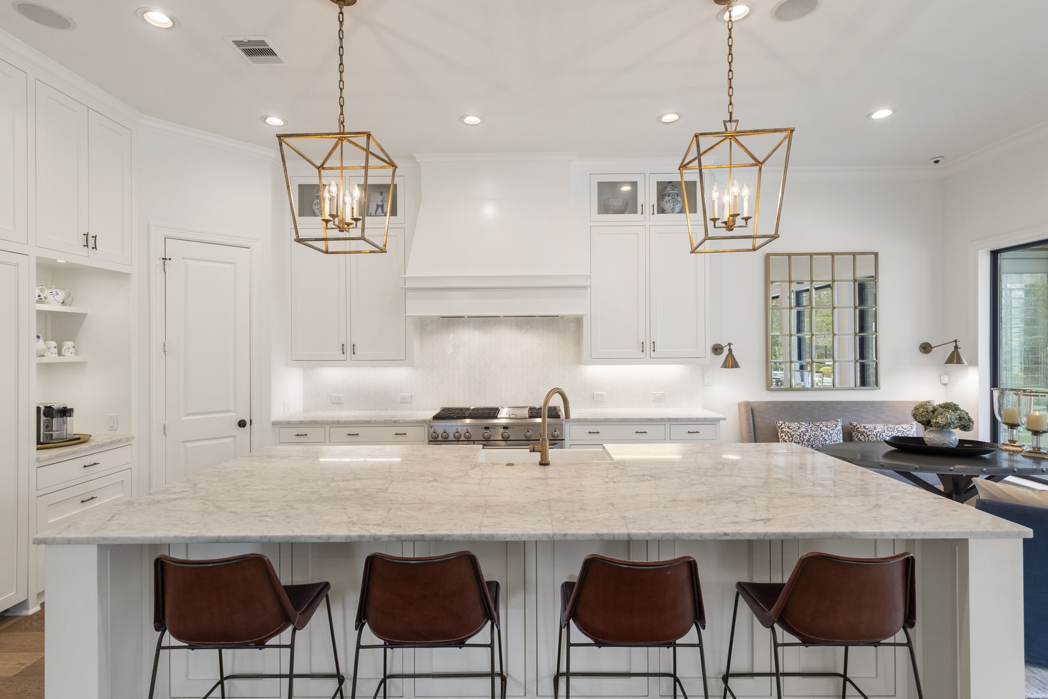 70 Lake Reverie Place Tomball, TX 77375 - Photo 8 of 33 a kitchen with stainless steel appliances granite countertop a table chairs in it white cabinets and a wooden floors