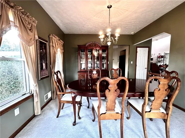 a view of a dining room with furniture and window