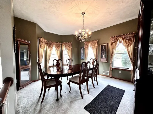 a view of a dining room with furniture and window