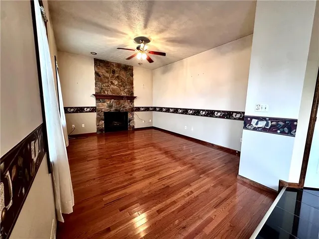 a view of a livingroom with furniture hardwood floor and a ceiling fan