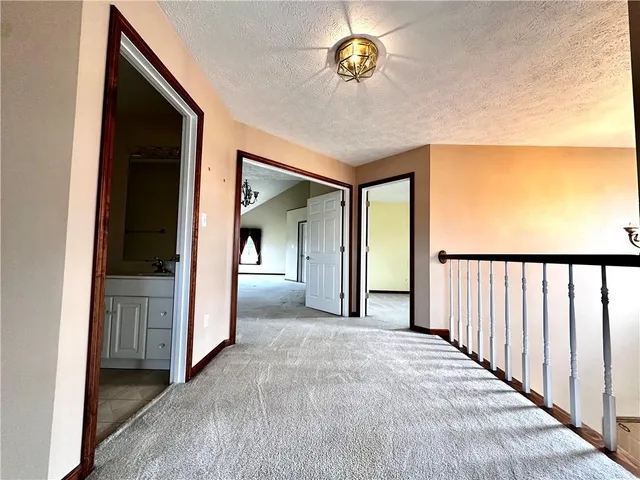 a view of a hallway with a chandelier