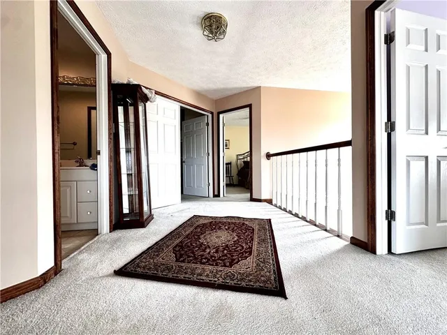 a view of a hallway with wooden floor and furniture