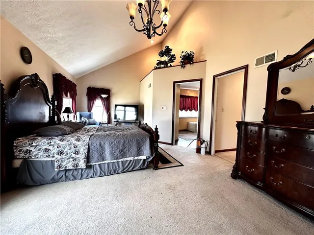 a bedroom with a bed window and dresser