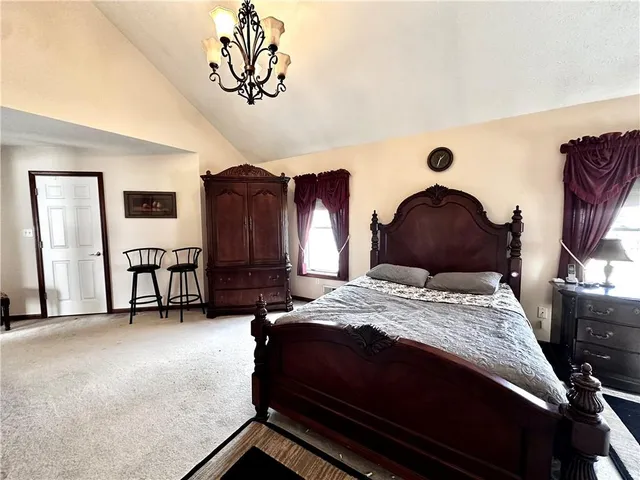 a bedroom with bed and a chandelier