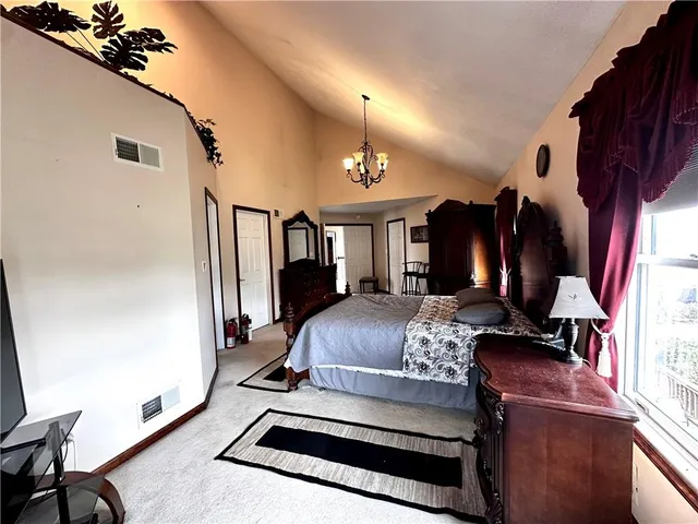 a bedroom with furniture and a chandelier