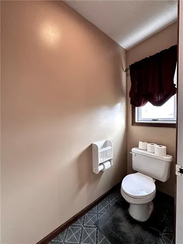 a bathroom with a toilet a sink and a mirror