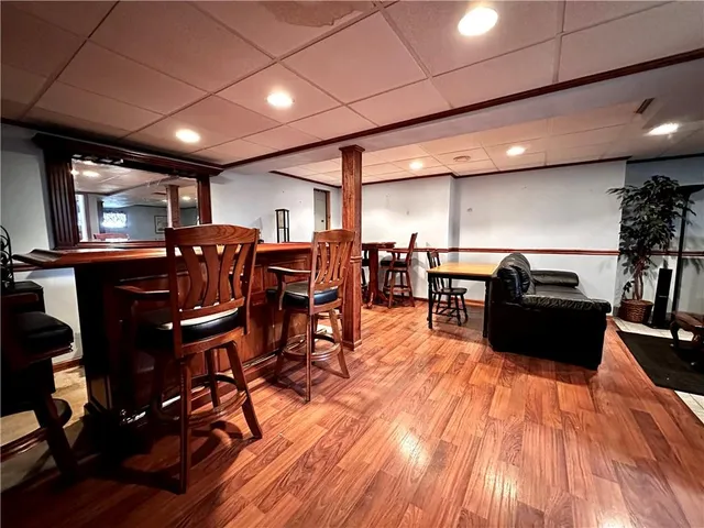 a living room with lots of furniture and wooden floors