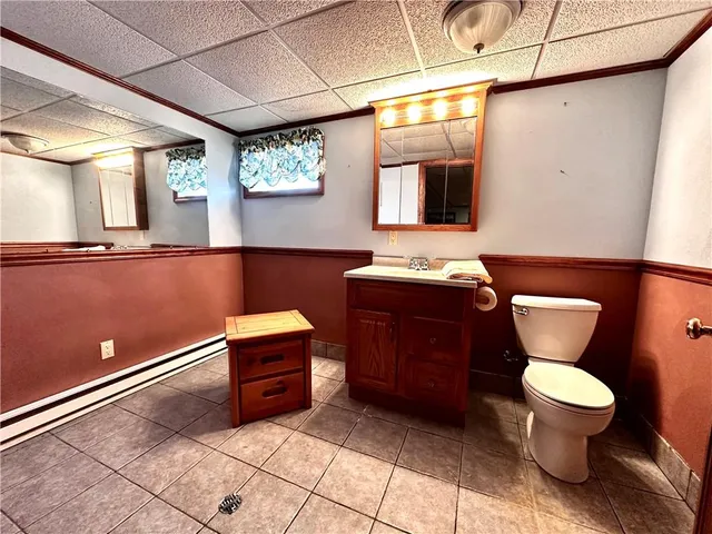 a bathroom with a toilet a sink and mirror