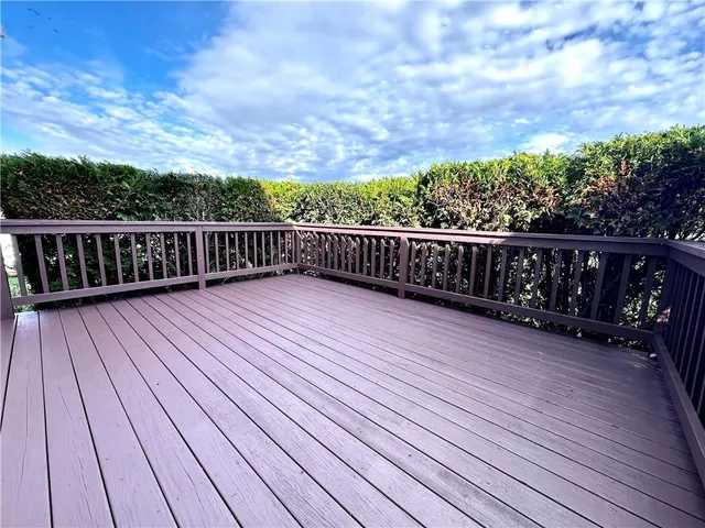 a view of deck with wooden floor and fence