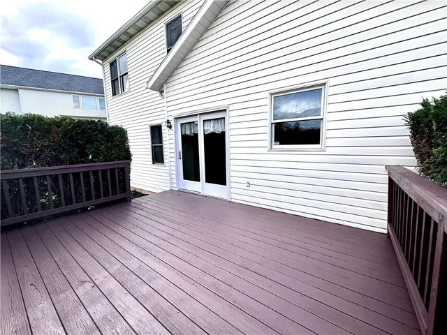 a view of a house with wooden deck