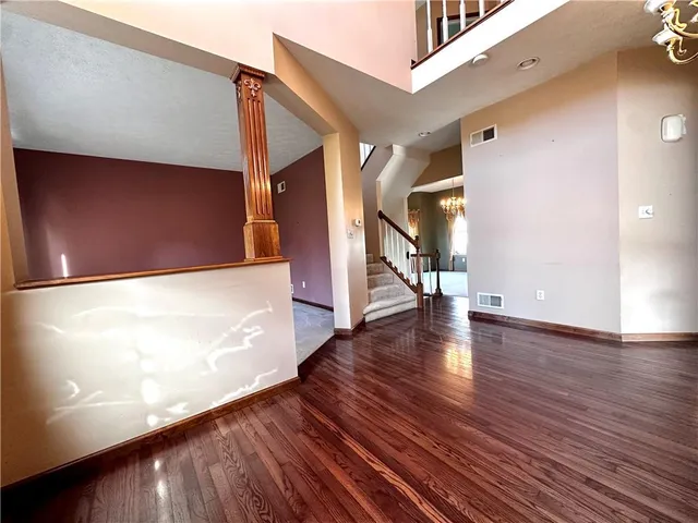 a view of hallway with stairs and wooden floor