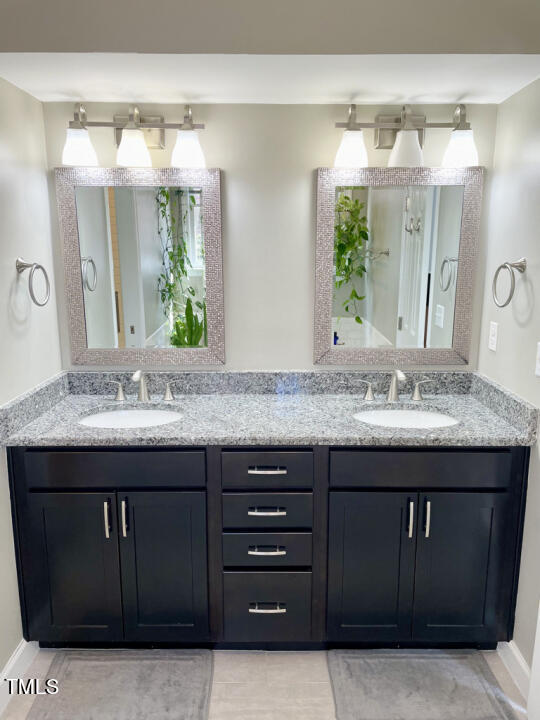 107 Legacy Lane Durham, NC 27713 - Photo 11 of 23 a bathroom with a granite countertop sink and a mirror