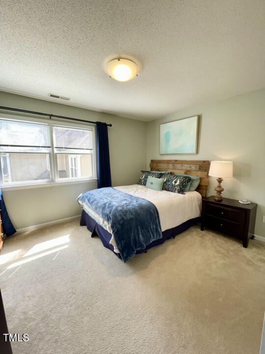 107 Legacy Lane Durham, NC 27713 - Photo 14 of 23 a bedroom with a bed and window