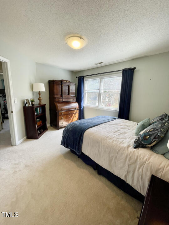 107 Legacy Lane Durham, NC 27713 - Photo 15 of 23 a bedroom with a bed and dresser