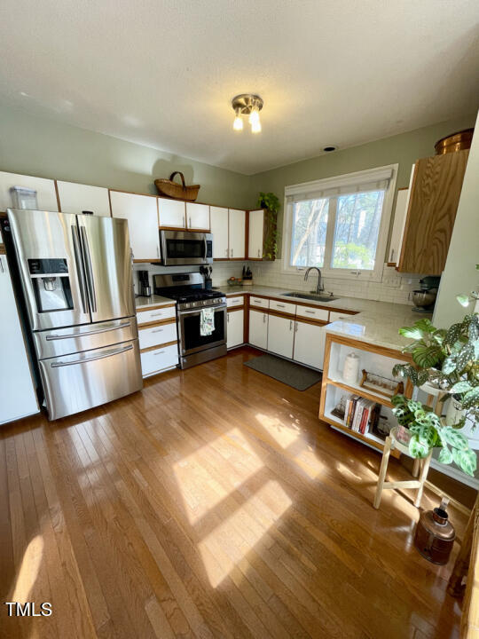 107 Legacy Lane Durham, NC 27713 - Photo 2 of 23 a living room with stainless steel appliances furniture and a kitchen view