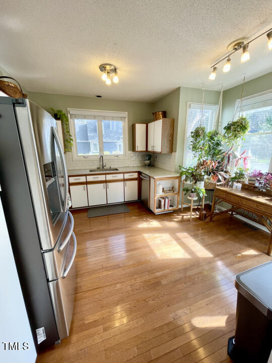 107 Legacy Lane Durham, NC 27713 - Photo 3 of 23 a kitchen with stainless steel appliances a refrigerator a sink a stove and white cabinets