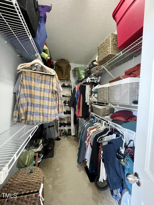 107 Legacy Lane Durham, NC 27713 - Photo 10 of 23 a view of walk in closet with clothes and shoes