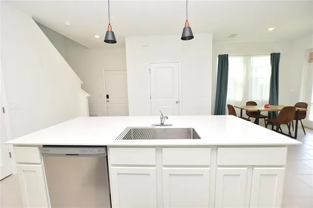 a kitchen with a sink and a refrigerator