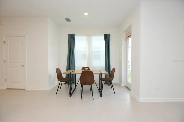 a view of a dining room with furniture and window