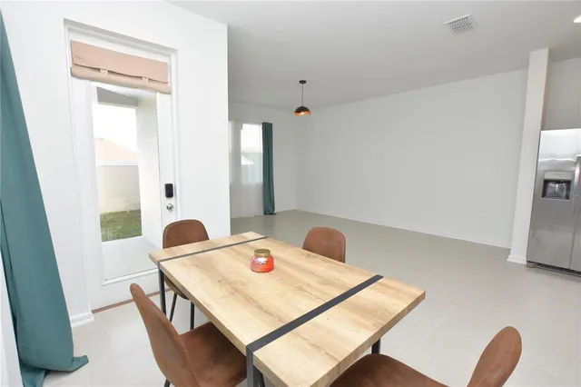a dining room with a table and chairs