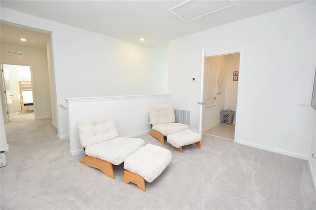 a living room with a baby crib furniture and a window
