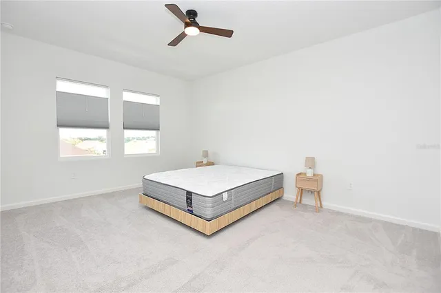 a spacious bedroom with a bed and table