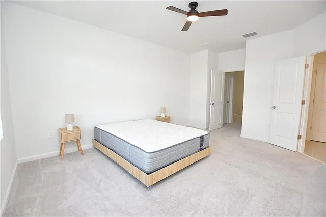 a spacious bathroom with a shower sink and mirror