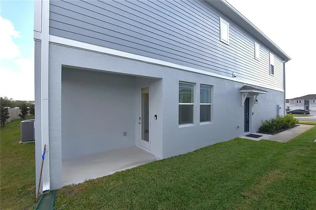 a view of backyard with potted plants and floor to ceiling window