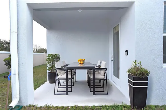 a view of outdoor dining space with a table and chairs