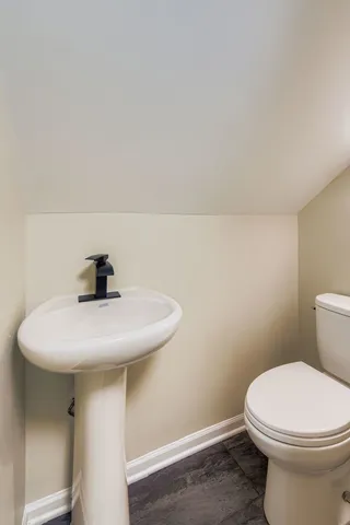 a bathroom with a sink a toilet and mirror
