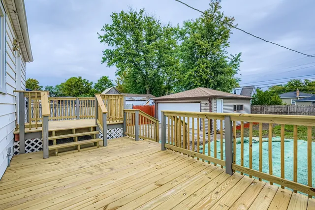 a balcony with wooden floor and fence
