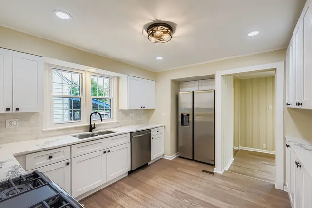 a kitchen with a sink cabinets and window