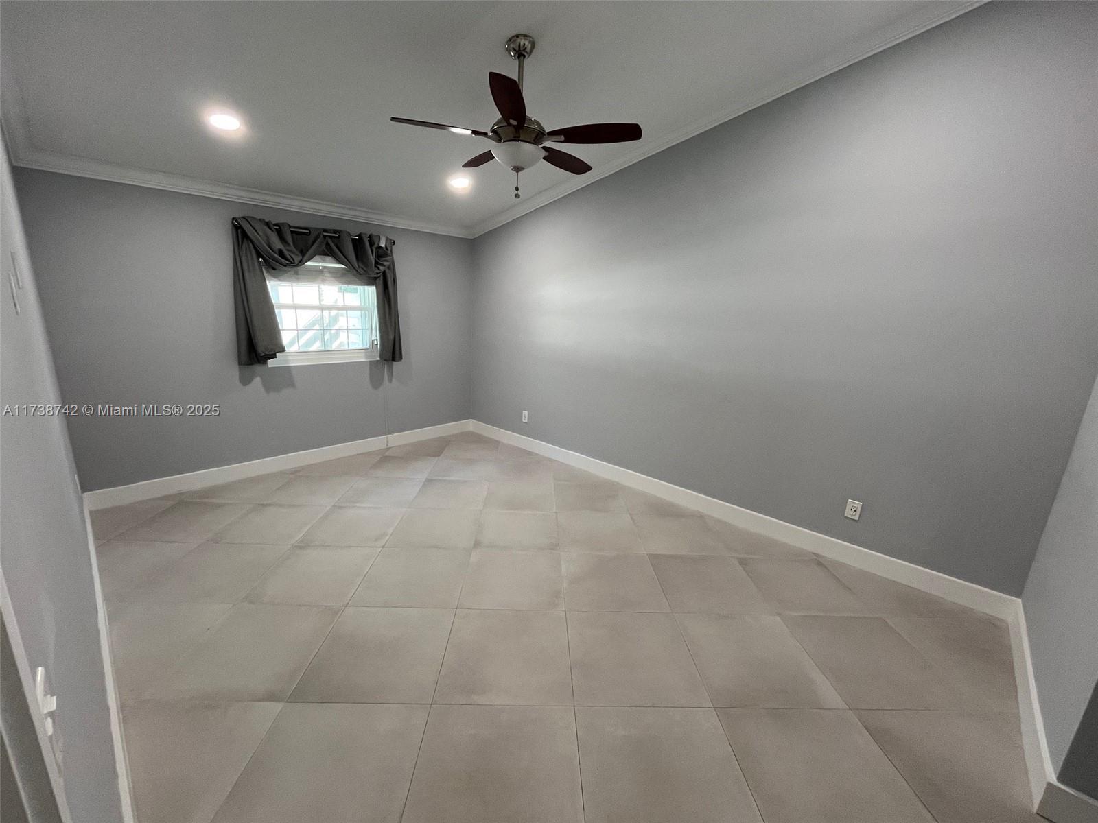 15023 Southwest 139th Place Miami, FL 33186 - Photo 13 of 31 wooden floor in an empty room with a window