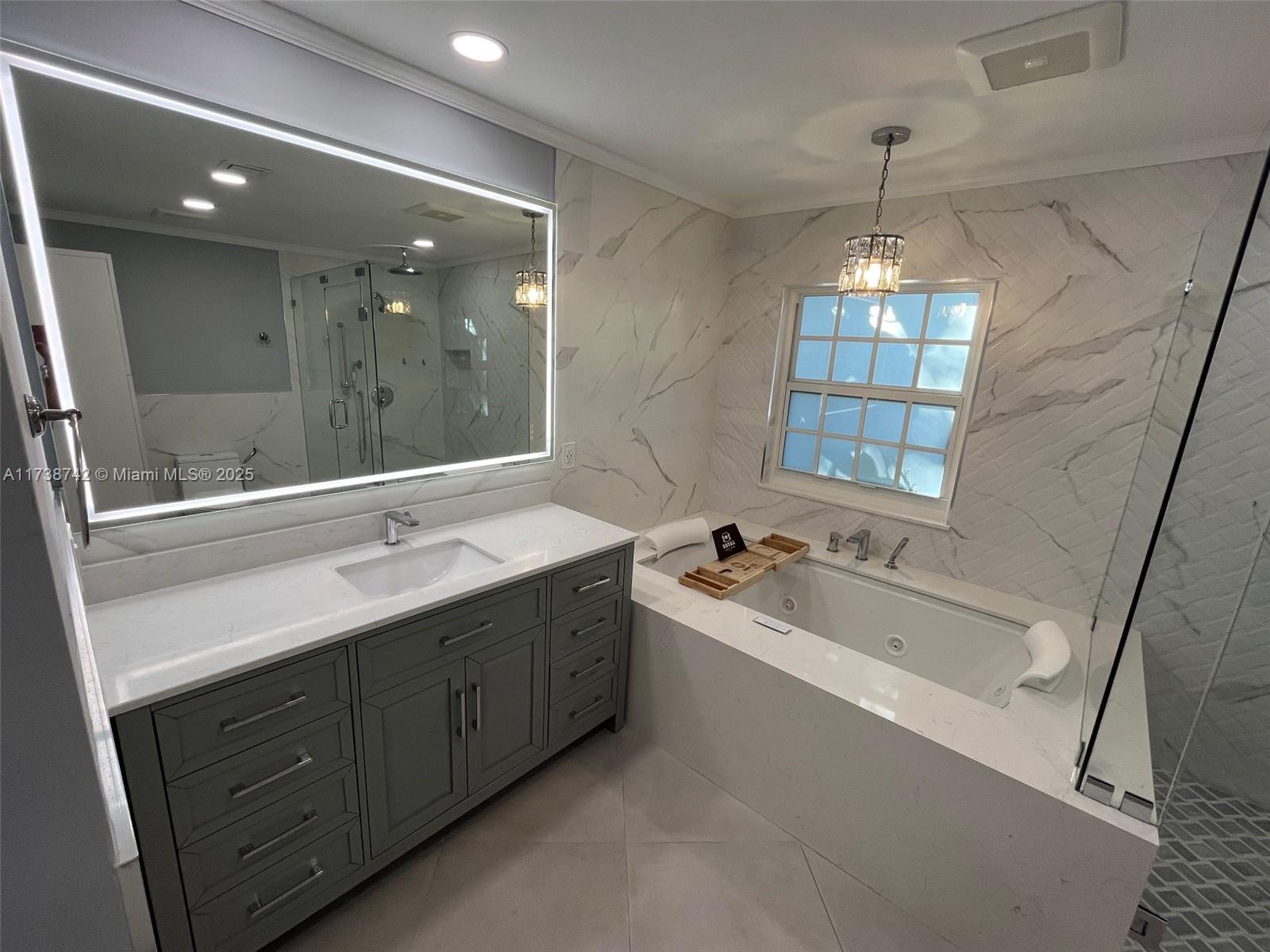 15023 Southwest 139th Place Miami, FL 33186 - Photo 19 of 31 a bathroom with a tub double sink mirror and
