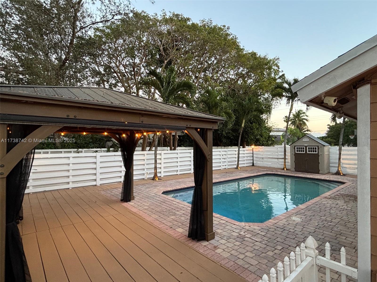 15023 Southwest 139th Place Miami, FL 33186 - Photo 2 of 31 a view of a swimming pool with a patio