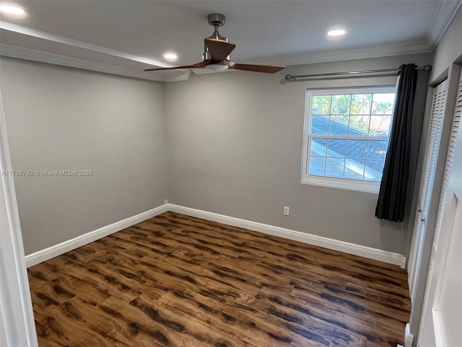 15023 Southwest 139th Place Miami, FL 33186 - Photo 23 of 31 a view of a room with a wooden floor and window