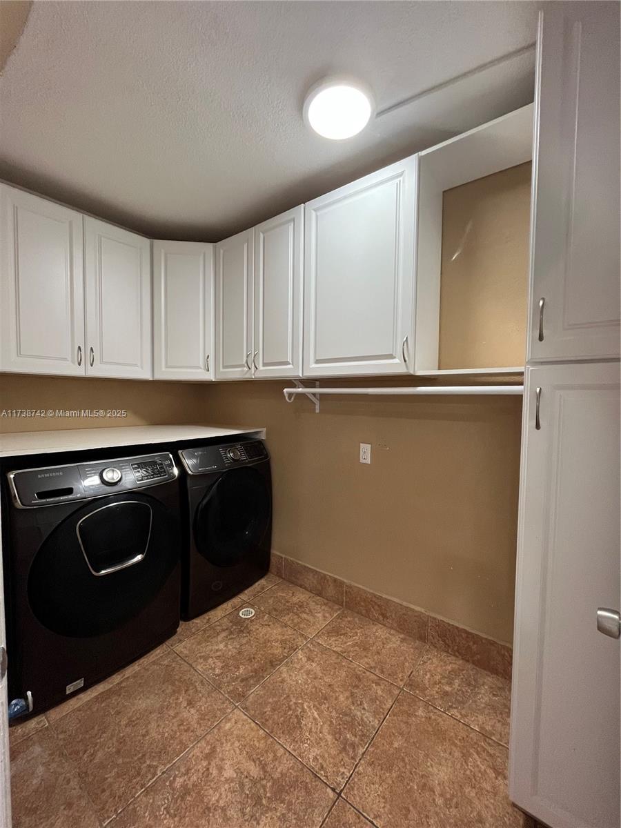 15023 Southwest 139th Place Miami, FL 33186 - Photo 25 of 31 a kitchen with a stove and a refrigerator