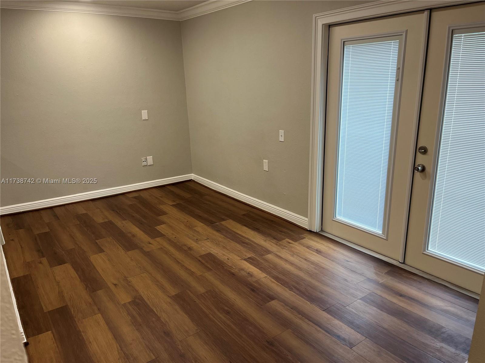 15023 Southwest 139th Place Miami, FL 33186 - Photo 28 of 31 an empty room with wooden floor and windows