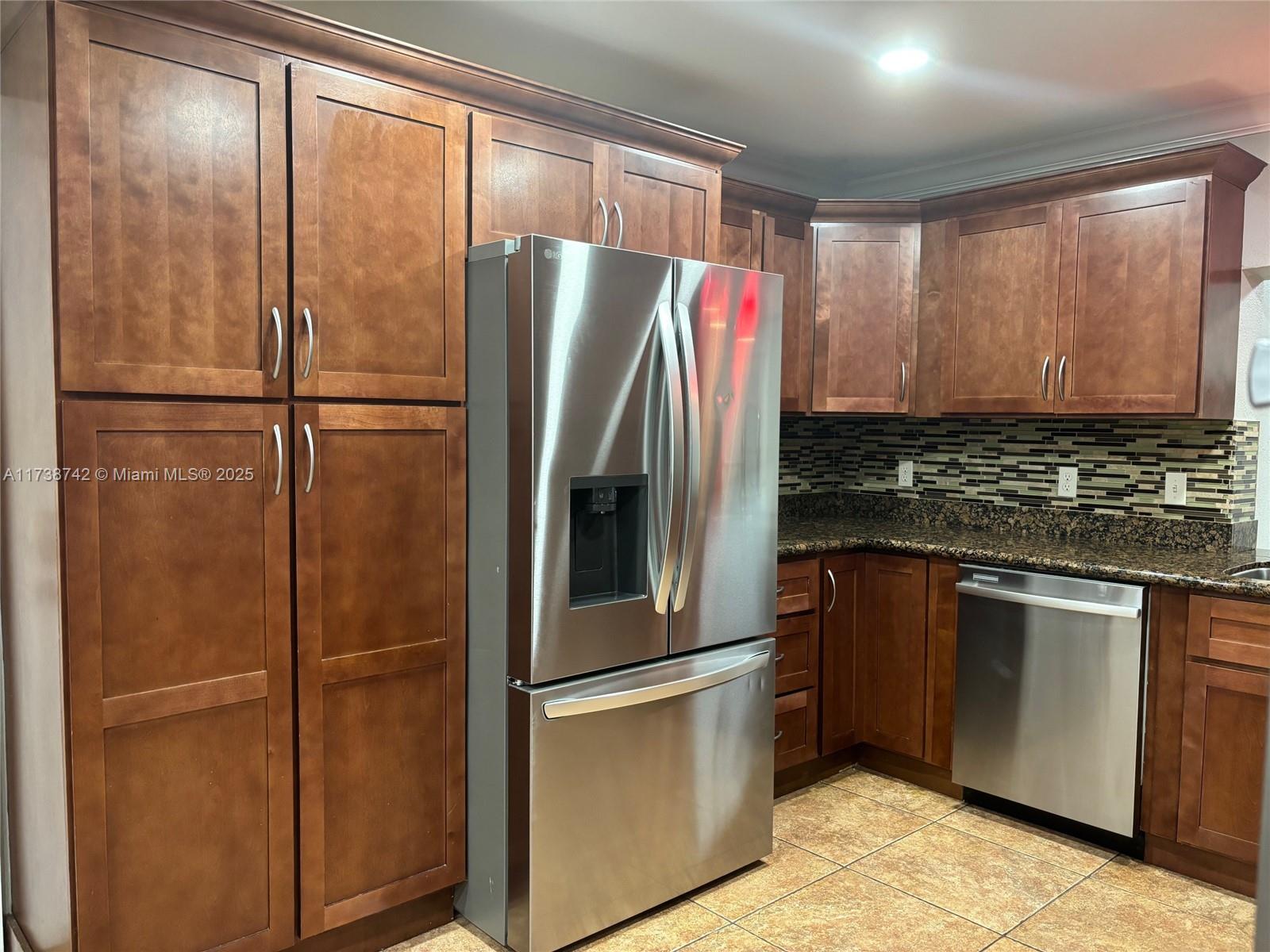 15023 Southwest 139th Place Miami, FL 33186 - Photo 8 of 31 a kitchen with stainless steel appliances granite countertop a refrigerator and a sink