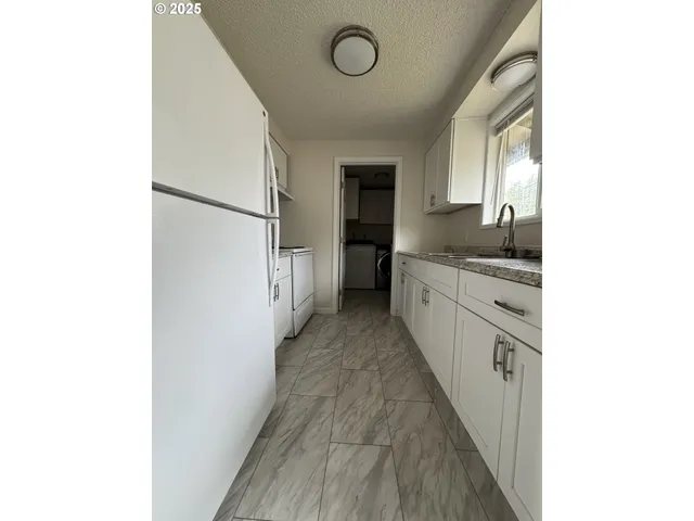 a kitchen with a sink and a refrigerator