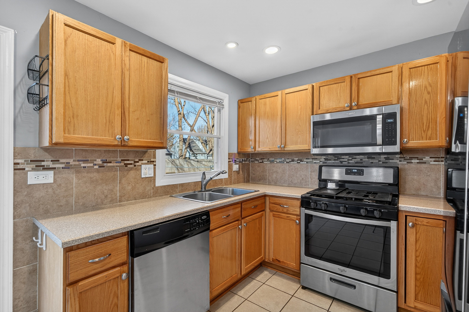 14 Devonshire Circle Elgin, IL 60123 - Photo 6 of 21 a kitchen with a sink a stove and cabinets