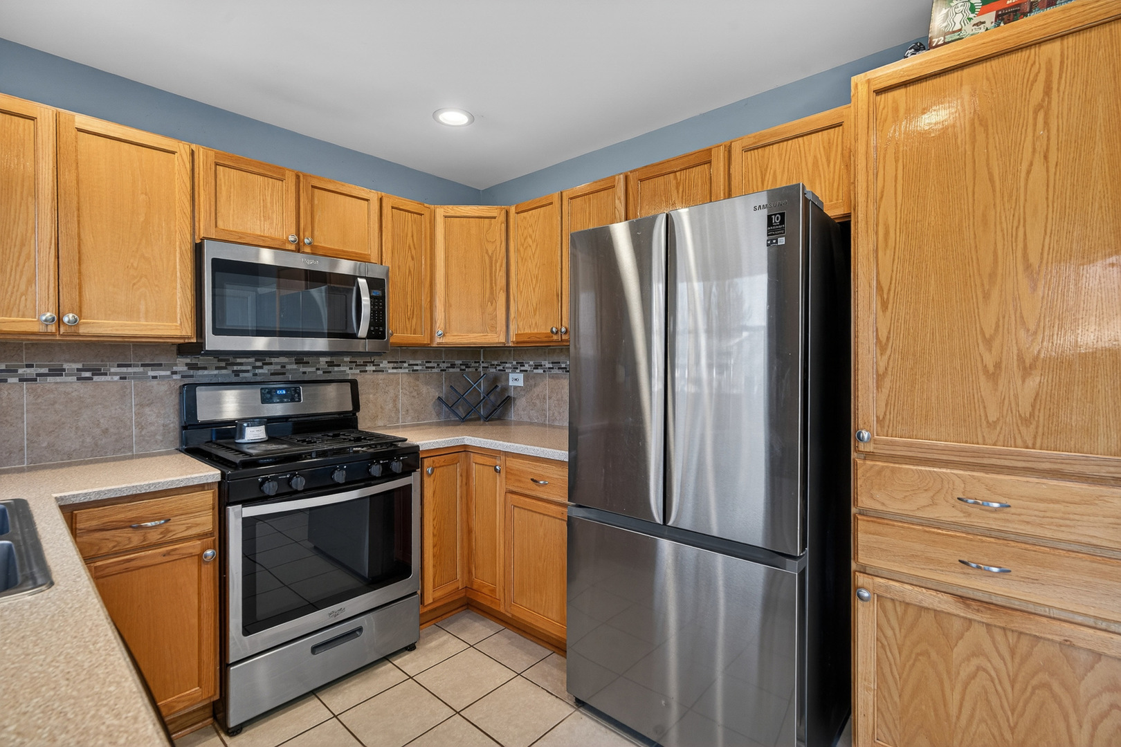 14 Devonshire Circle Elgin, IL 60123 - Photo 8 of 21 a kitchen with stainless steel appliances granite countertop a refrigerator stove and microwave