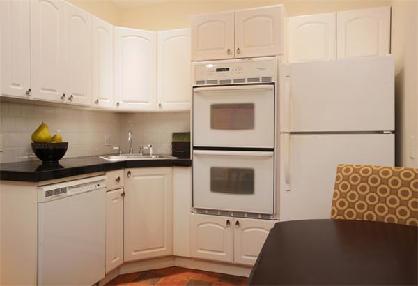 112 Pinckney Street, Unit 4 Boston, MA 02114 - Photo 5 of 6 a kitchen with white cabinets and white appliances