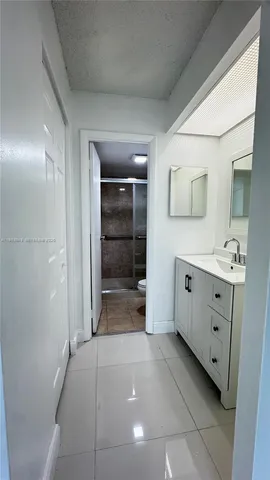 a bathroom with a sink a mirror and a shower