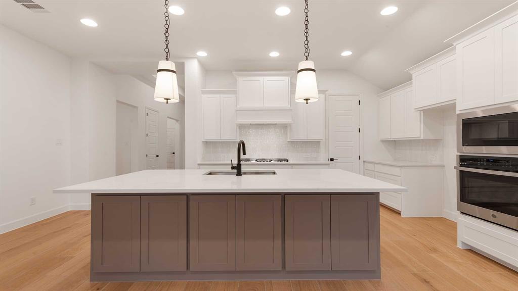 829 Stoney Bridge Way Lavon, TX 75166 - Photo 8 of 35 a kitchen with kitchen island a sink stainless steel appliances and cabinets