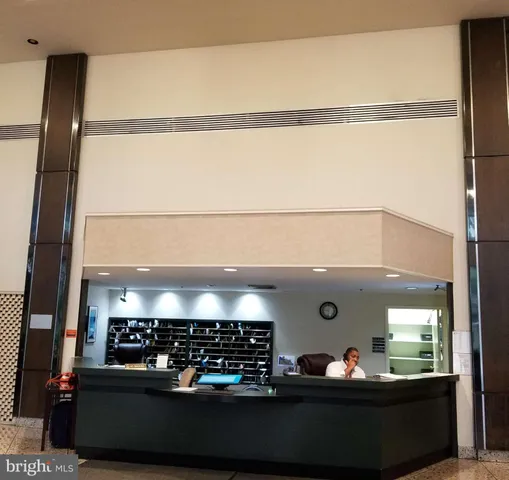 an aerial view of green landscape with trees houses and mountain view